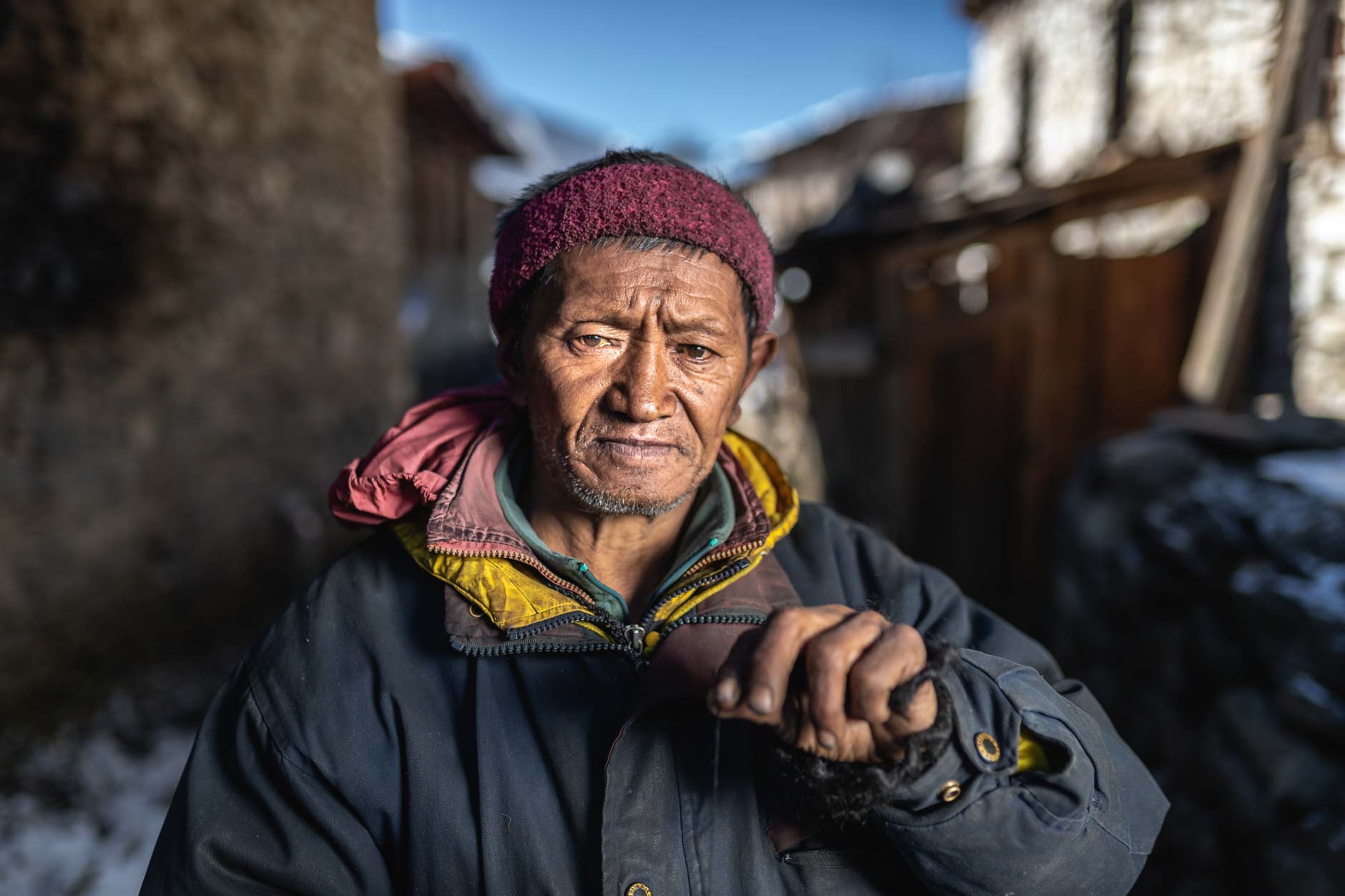 Portrait photography of an elderly Bhutanese villager in Merak