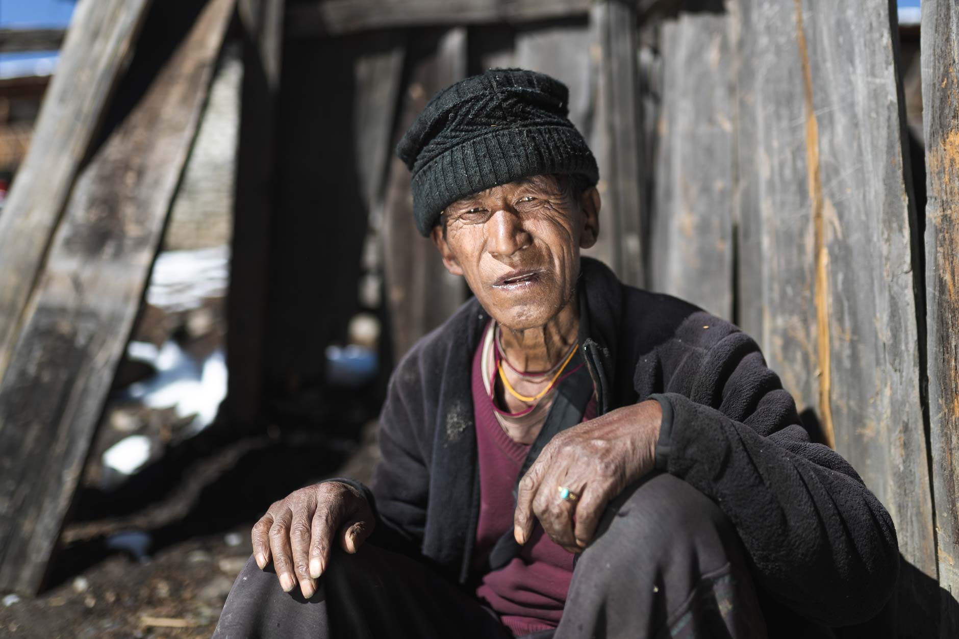 Portrait photography of an elderly Bhutanese villager in Merak