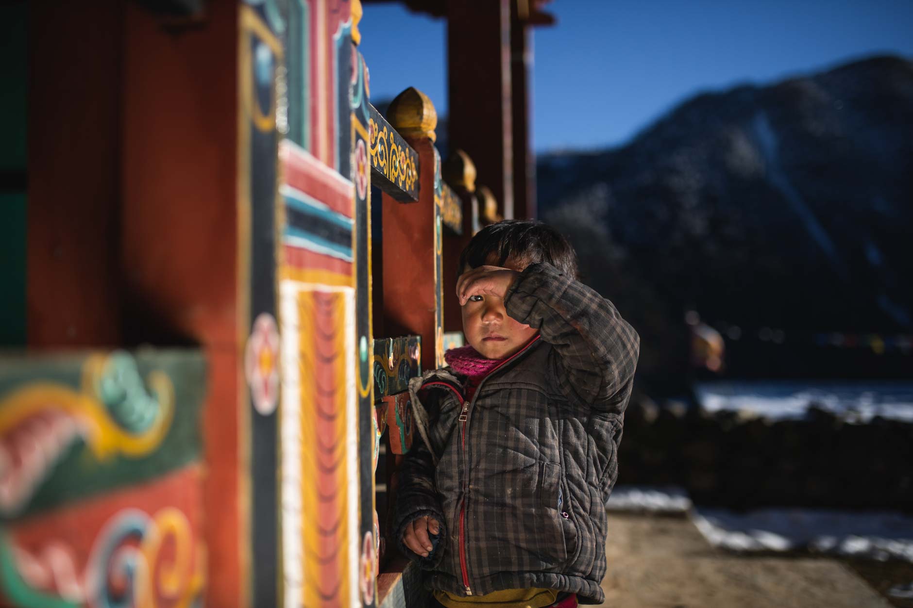 Street photography of a young boy at a temple in Merak, Bhutan