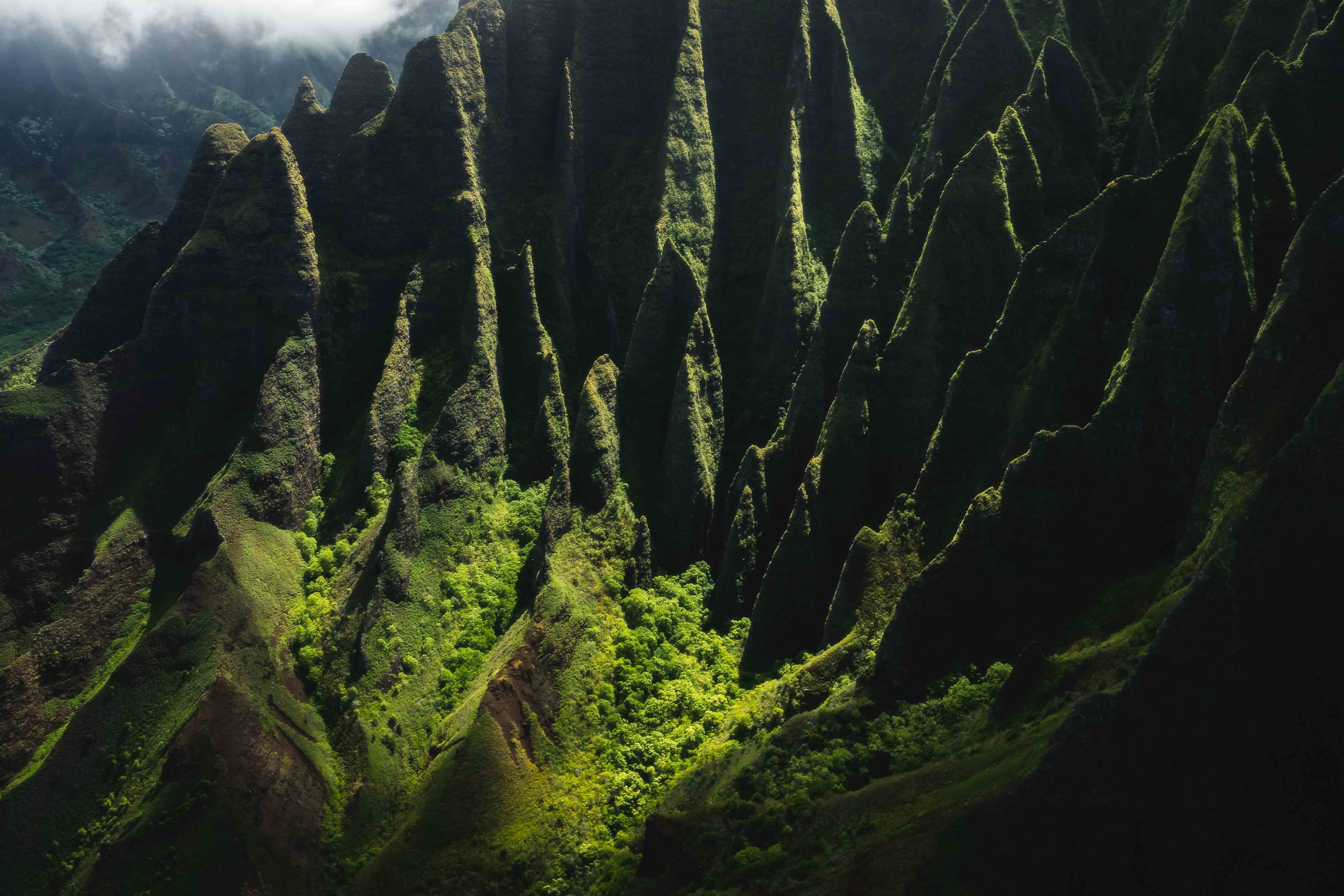Aerial photography of the Na Pali Coast ridge line at Kalalau Valley on Kauai, Hawaii. Photo taken from a doors off helicopter with Jack Harter Flights.