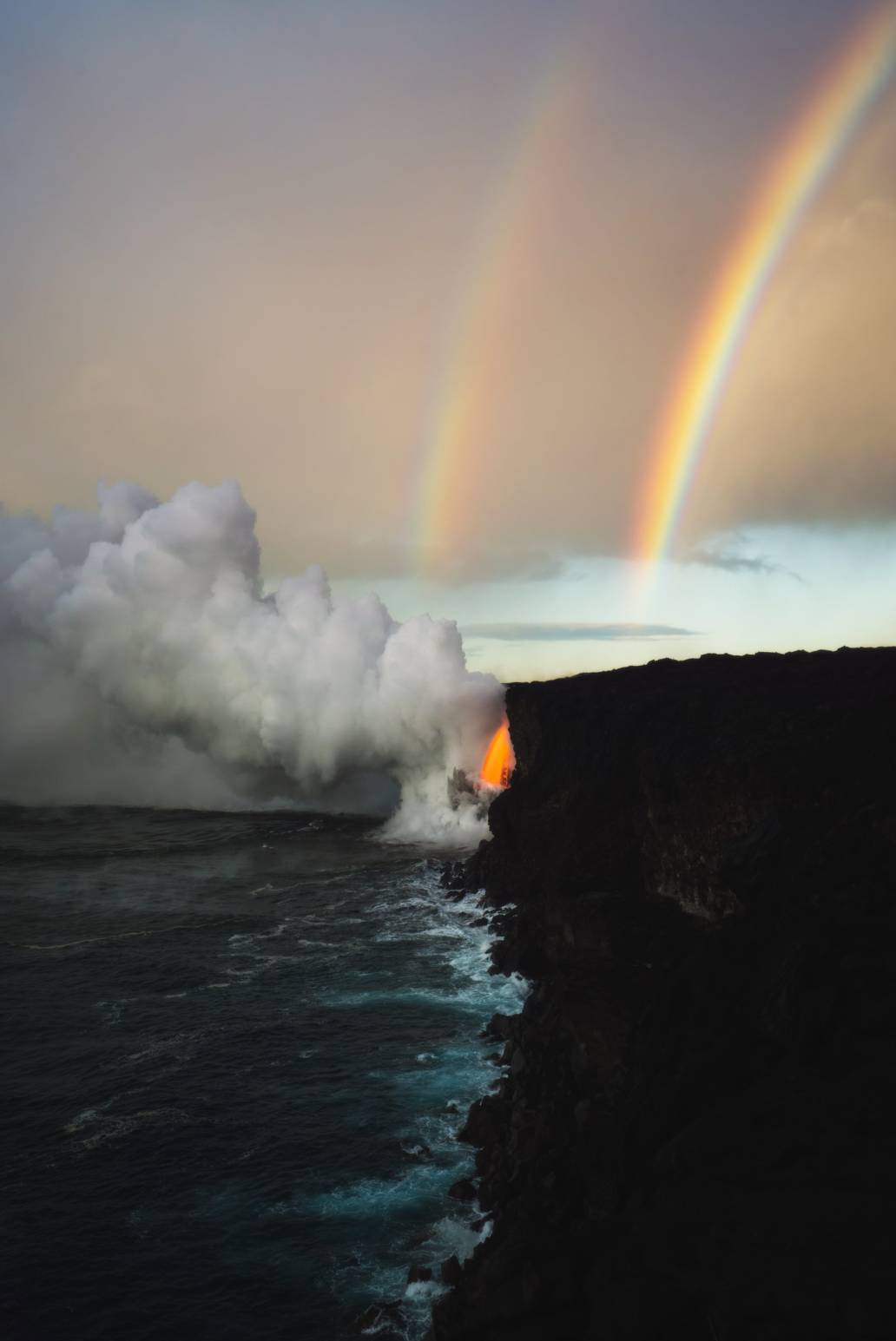 Photography of double Rainbows at a lava spout in Hawaii volcanoes national park