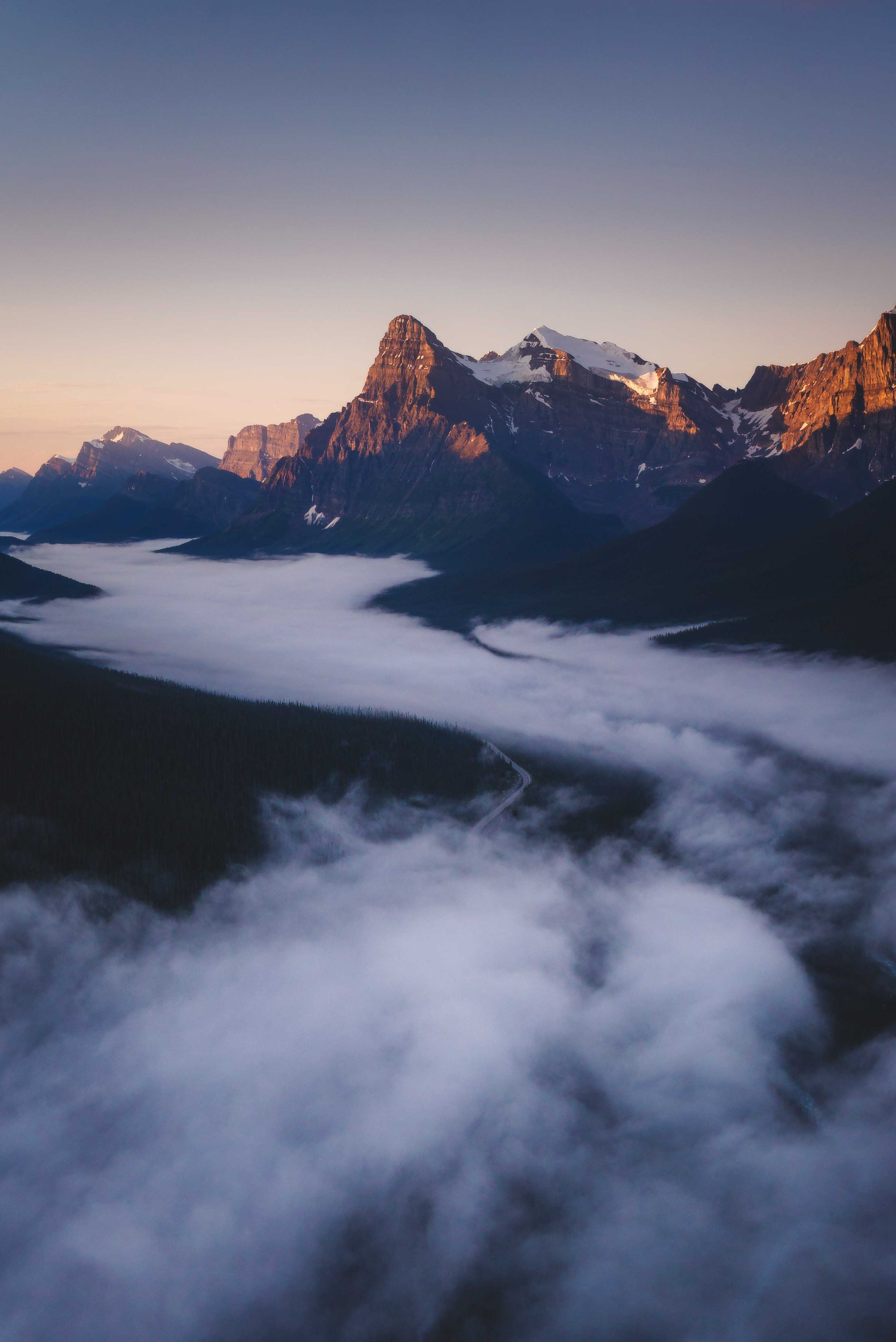 Aerial photography of Banff National Park during sunrise above the fog Photo by Andrew Studer