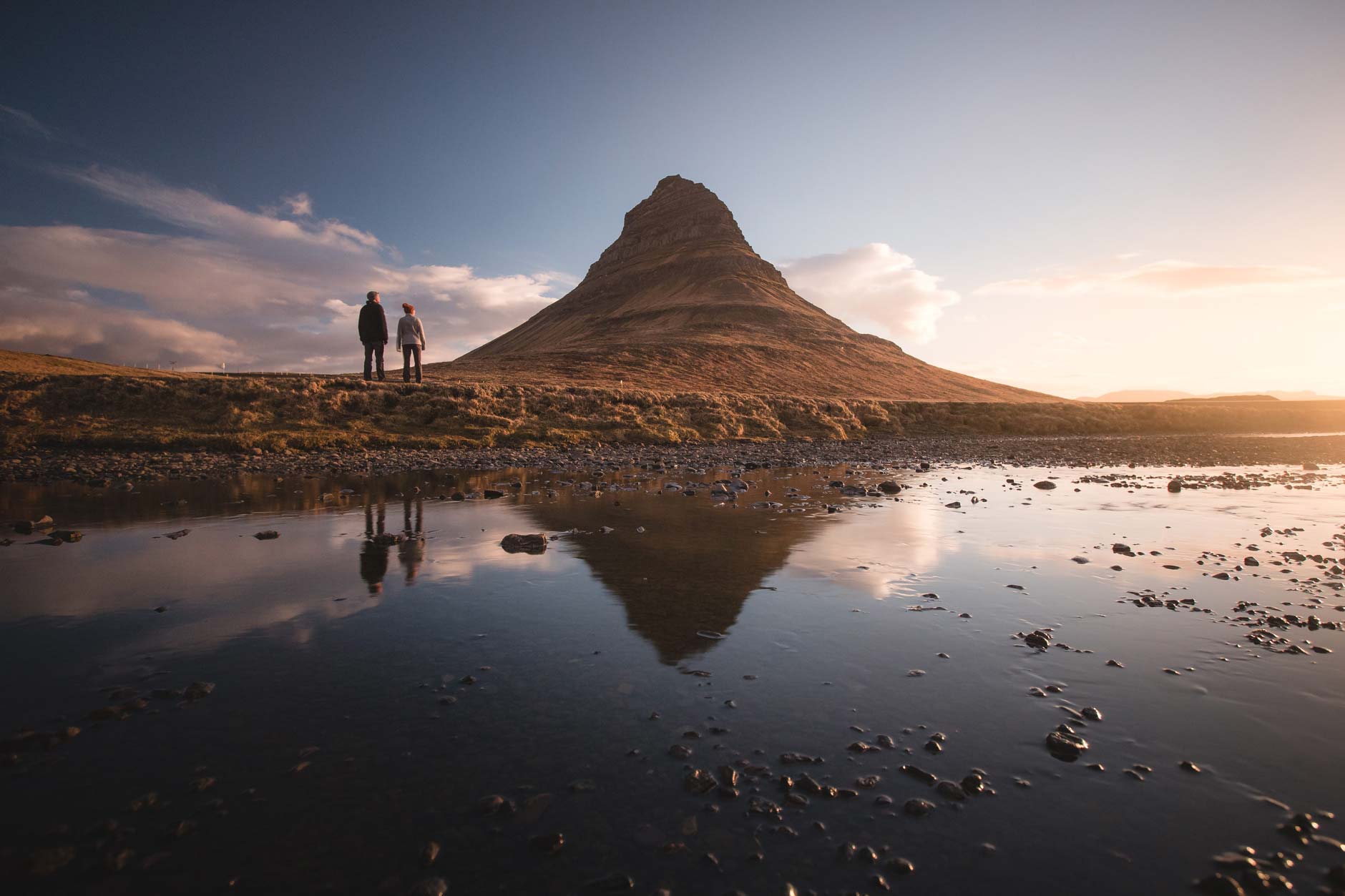Hanna Roshak and Andrew Studer stand at Kirkjufell Mountain in Iceland