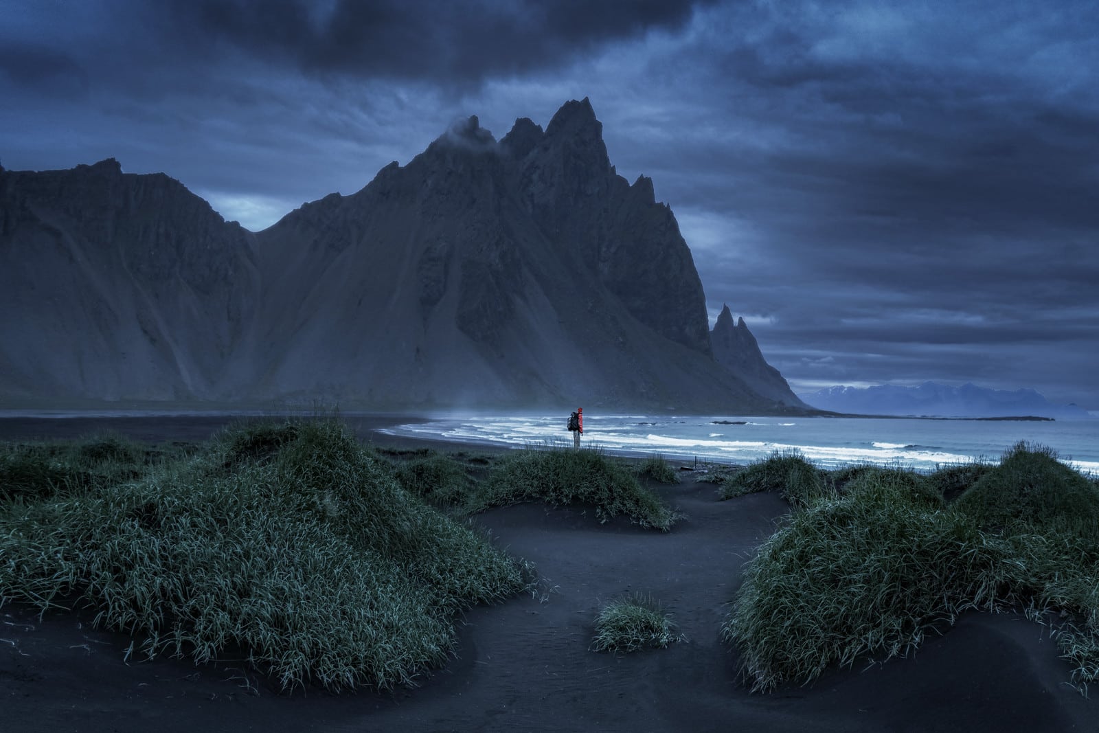 A person stands at Vestrahorn Stokksnes in Iceland
