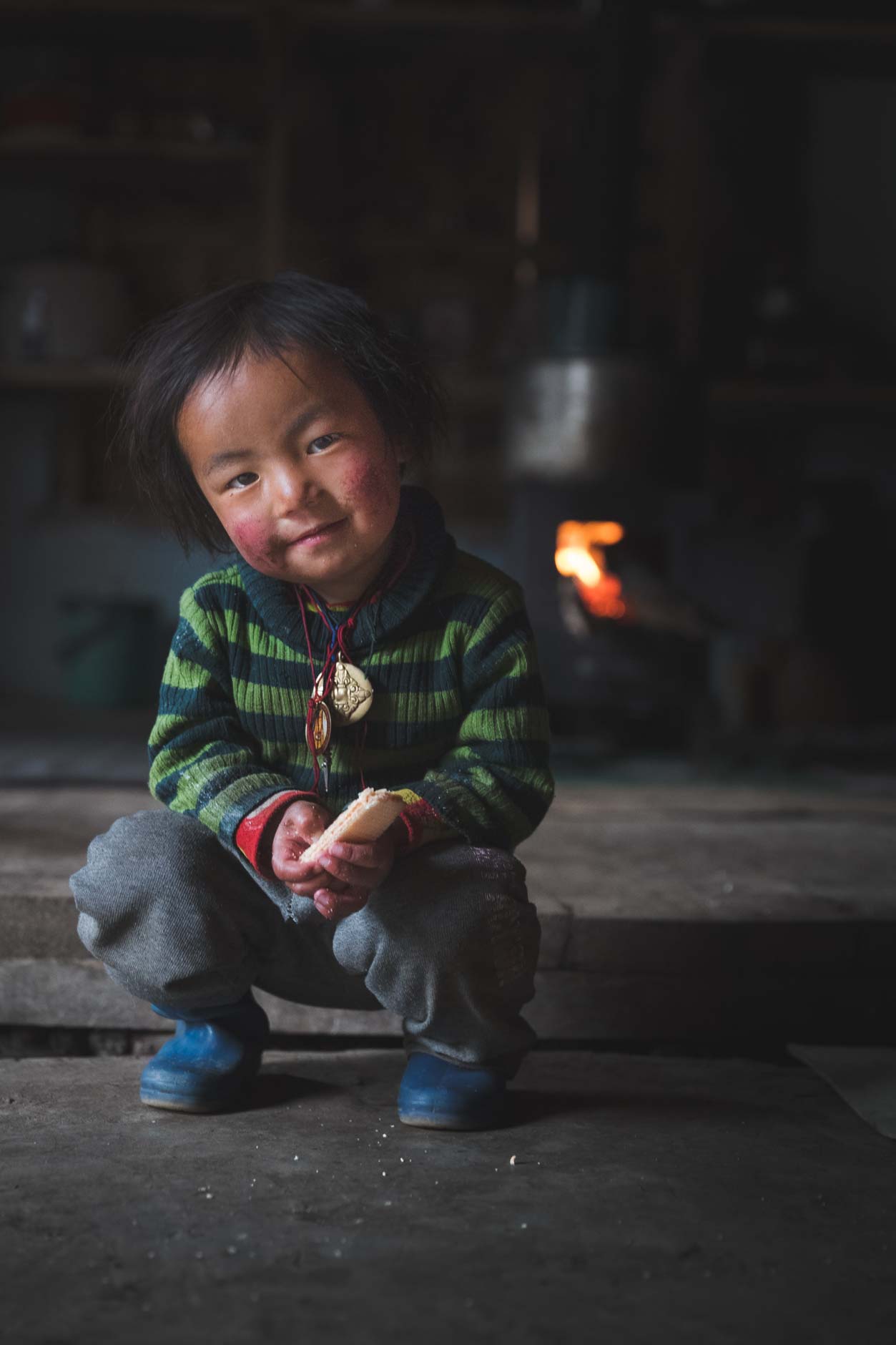 Portrait photography of a young boy sitting in Laya, Bhutan