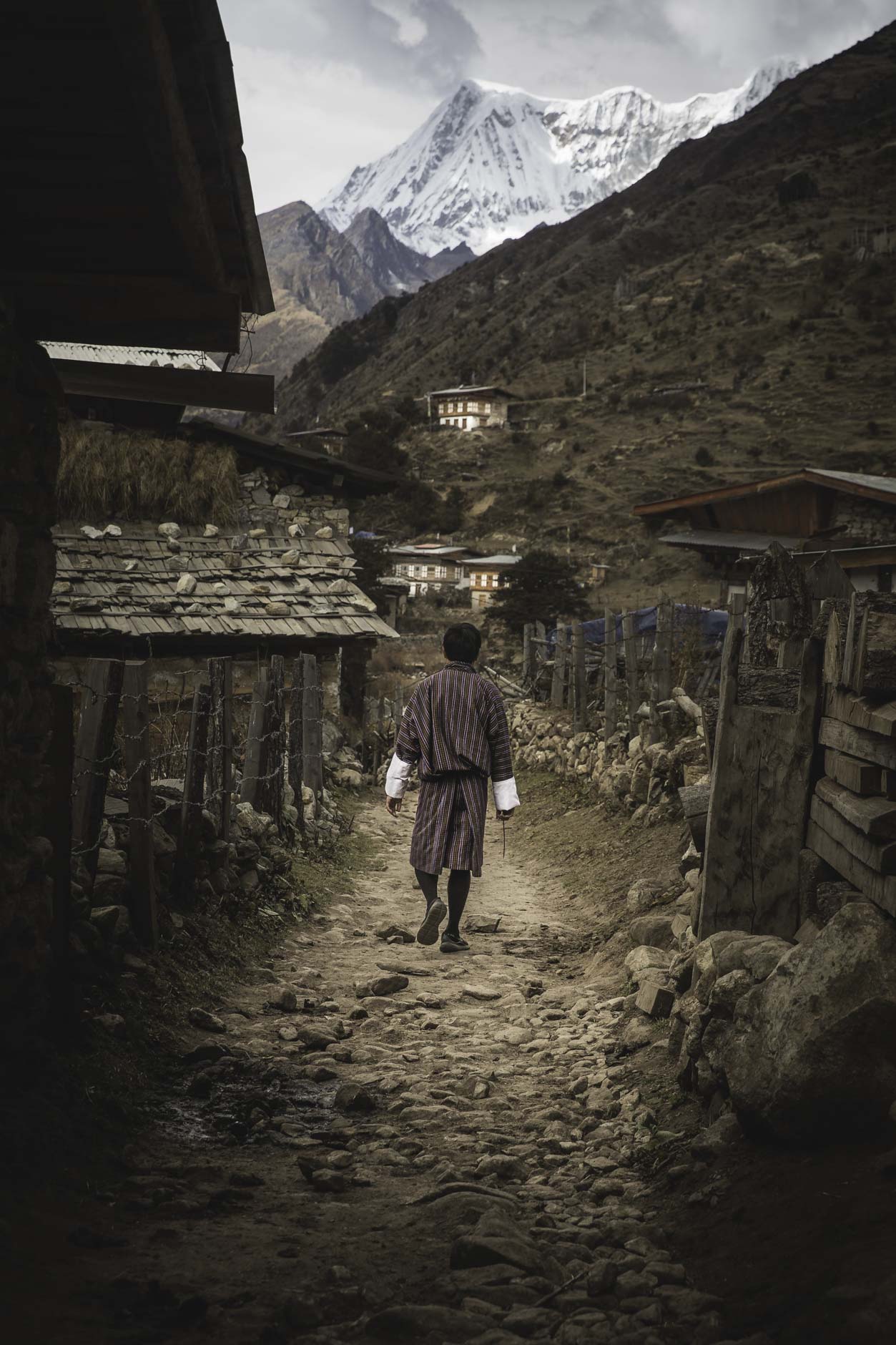 A man walks down a road in Laya, Bhutan