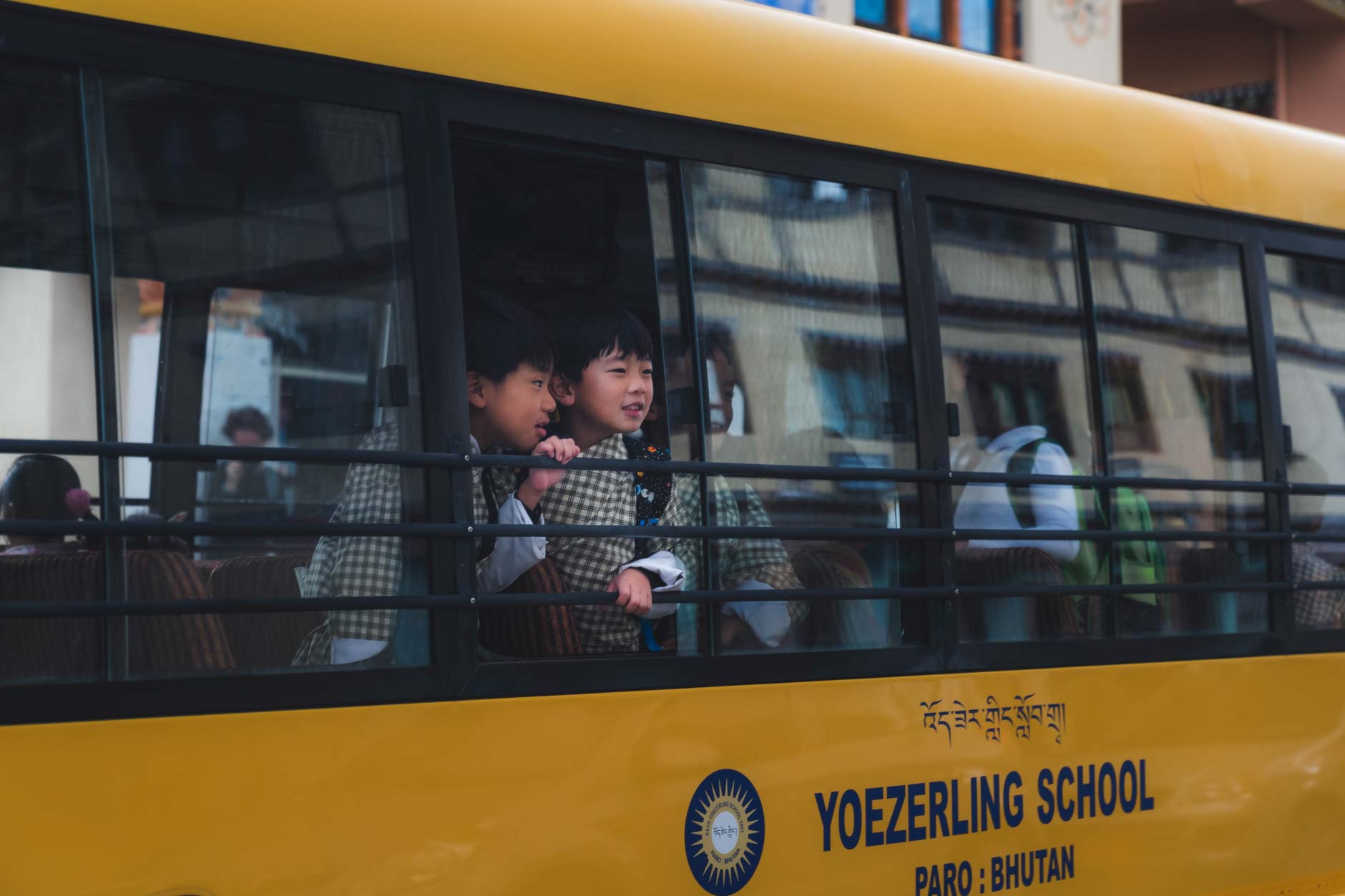Photography of two Bhutanese school children in a school bus in Paro, Bhutan