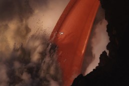 Photography of a drone flying next to a explosions at a lava fire hose in Hawaii Volcanoes National Park