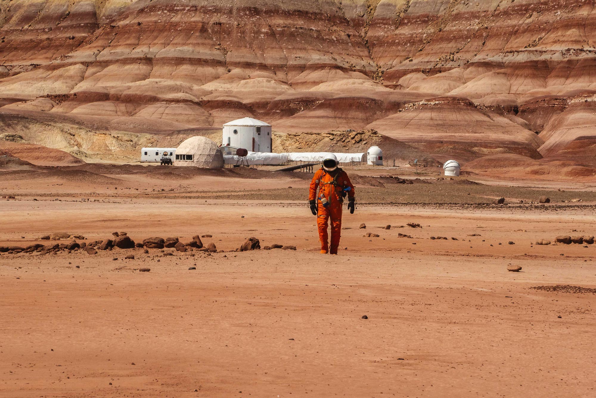 An astronaut walks through the 'Mars-like' landscape of the desert in Utah at a Mars Rover training station.