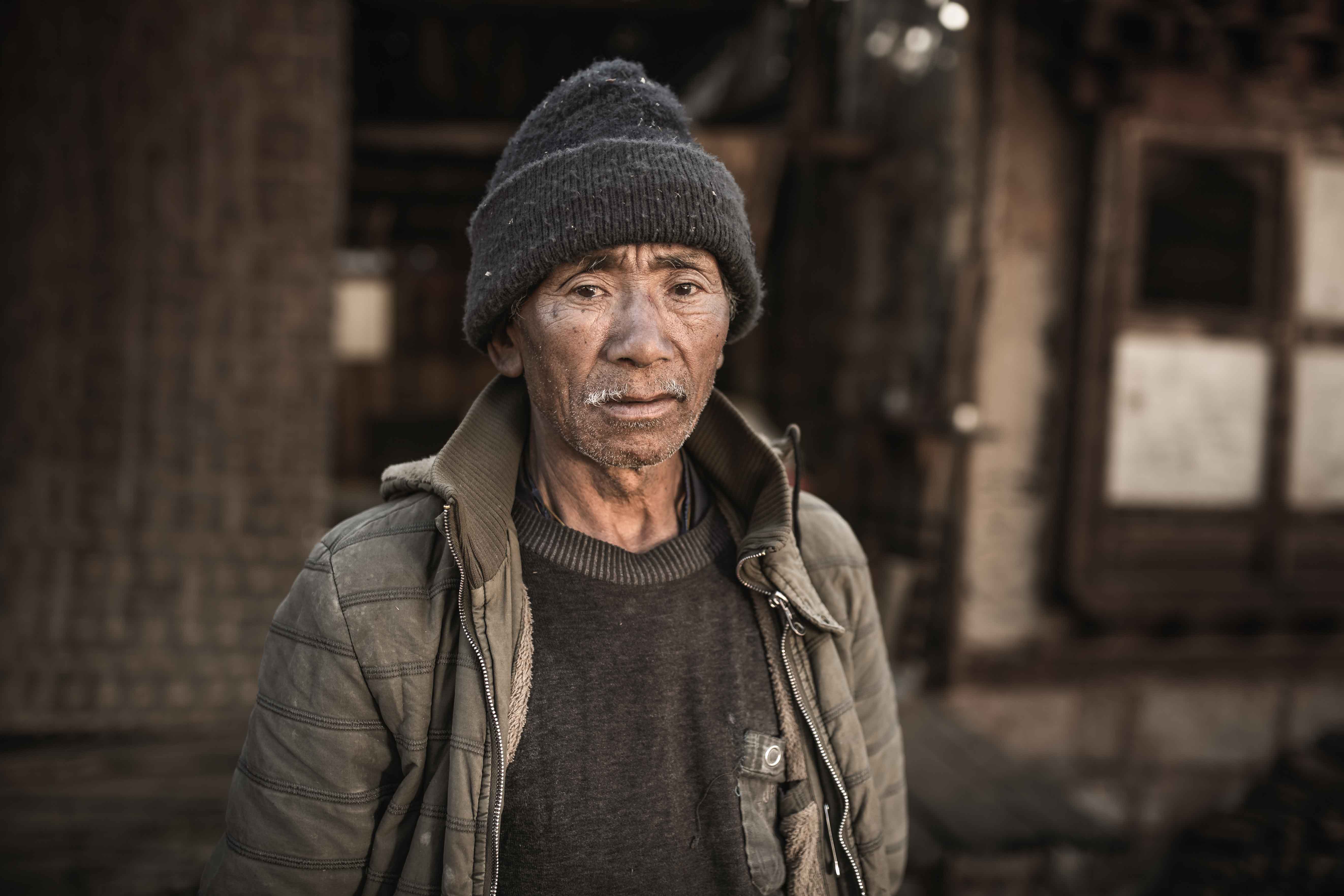 Portrait photography of a man in a village in Bhutan