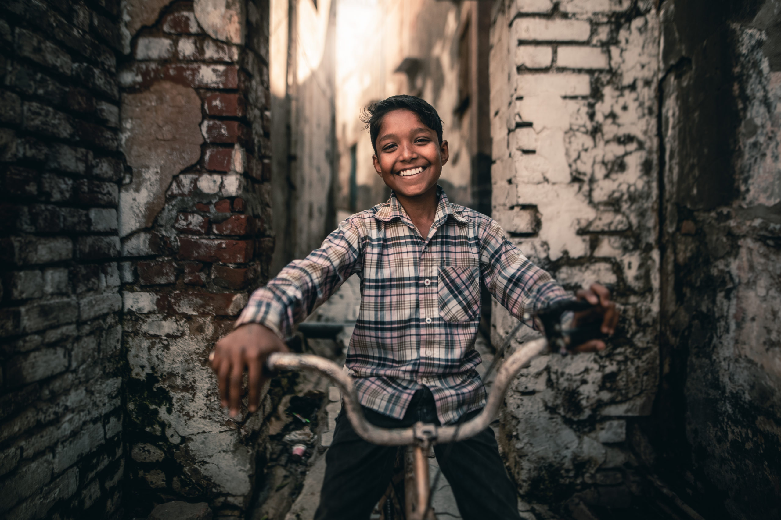 Portrait-Street Photography of a young boy on a bike in the streets of Mathura, India