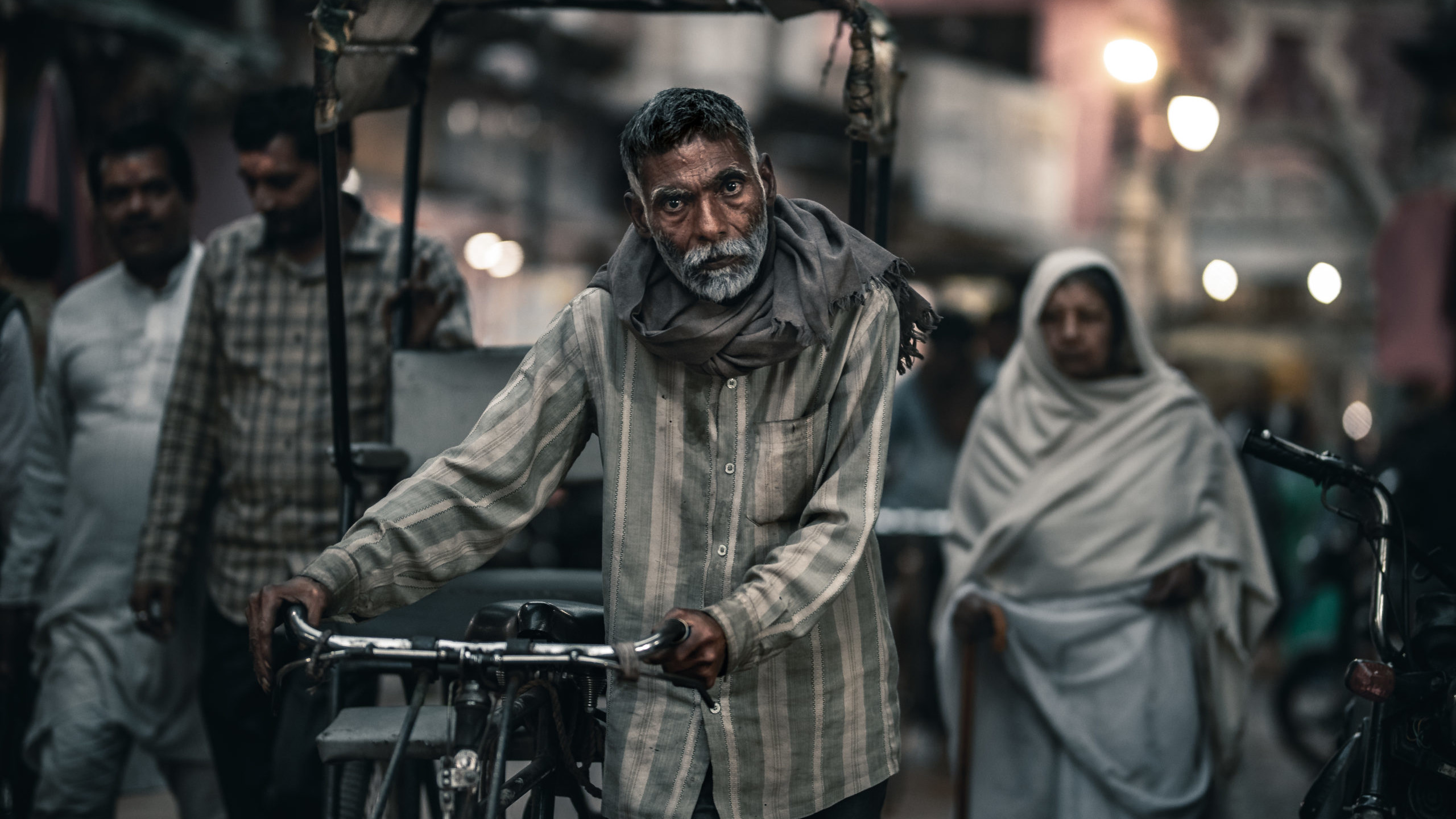 Portrait street photography of a rickshaw driver walking in the streets of Mathura, India
