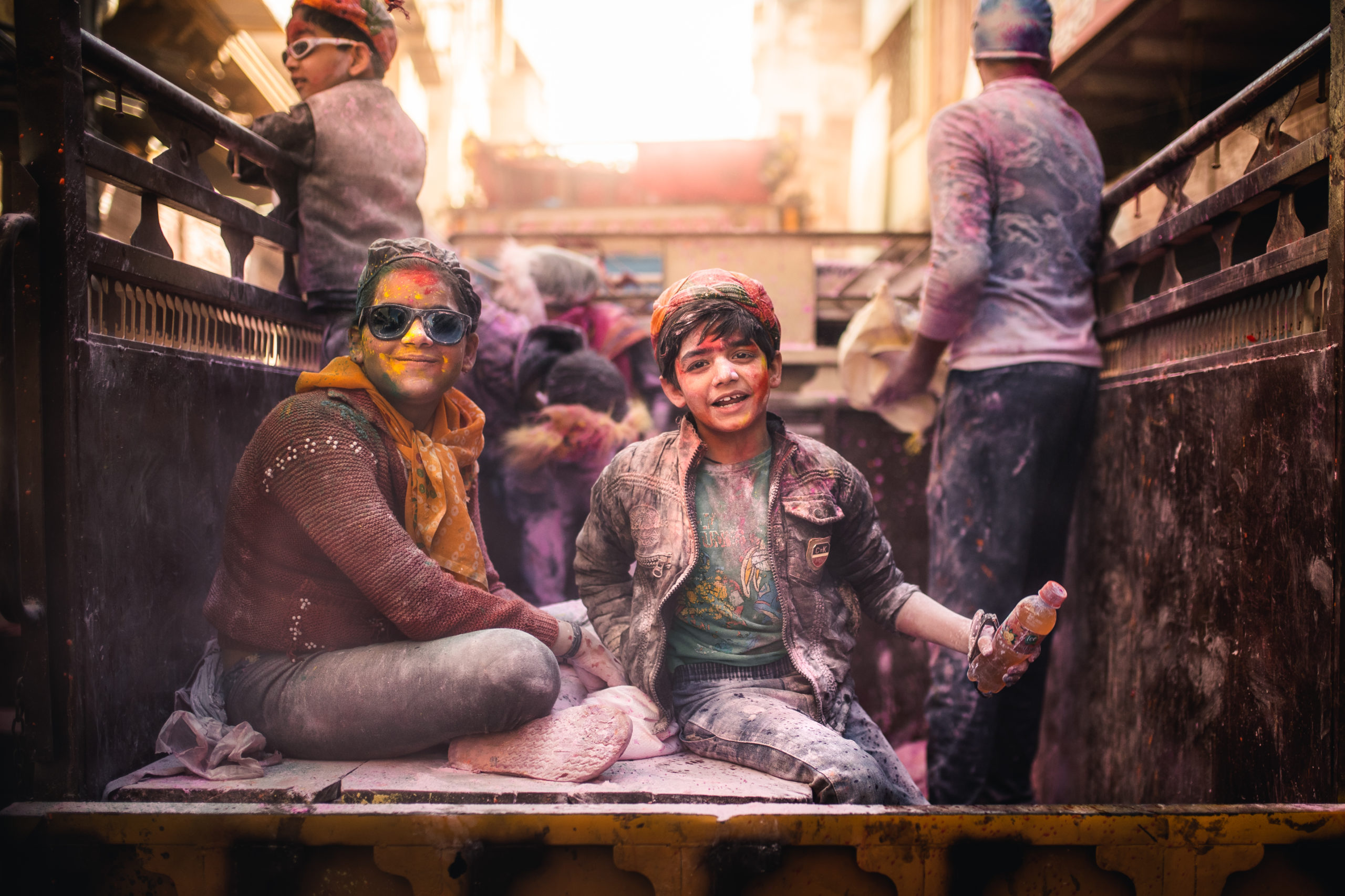 Street portrait photography of children covered in colorful Holi powder during the holi festival of colors in Mathura, India