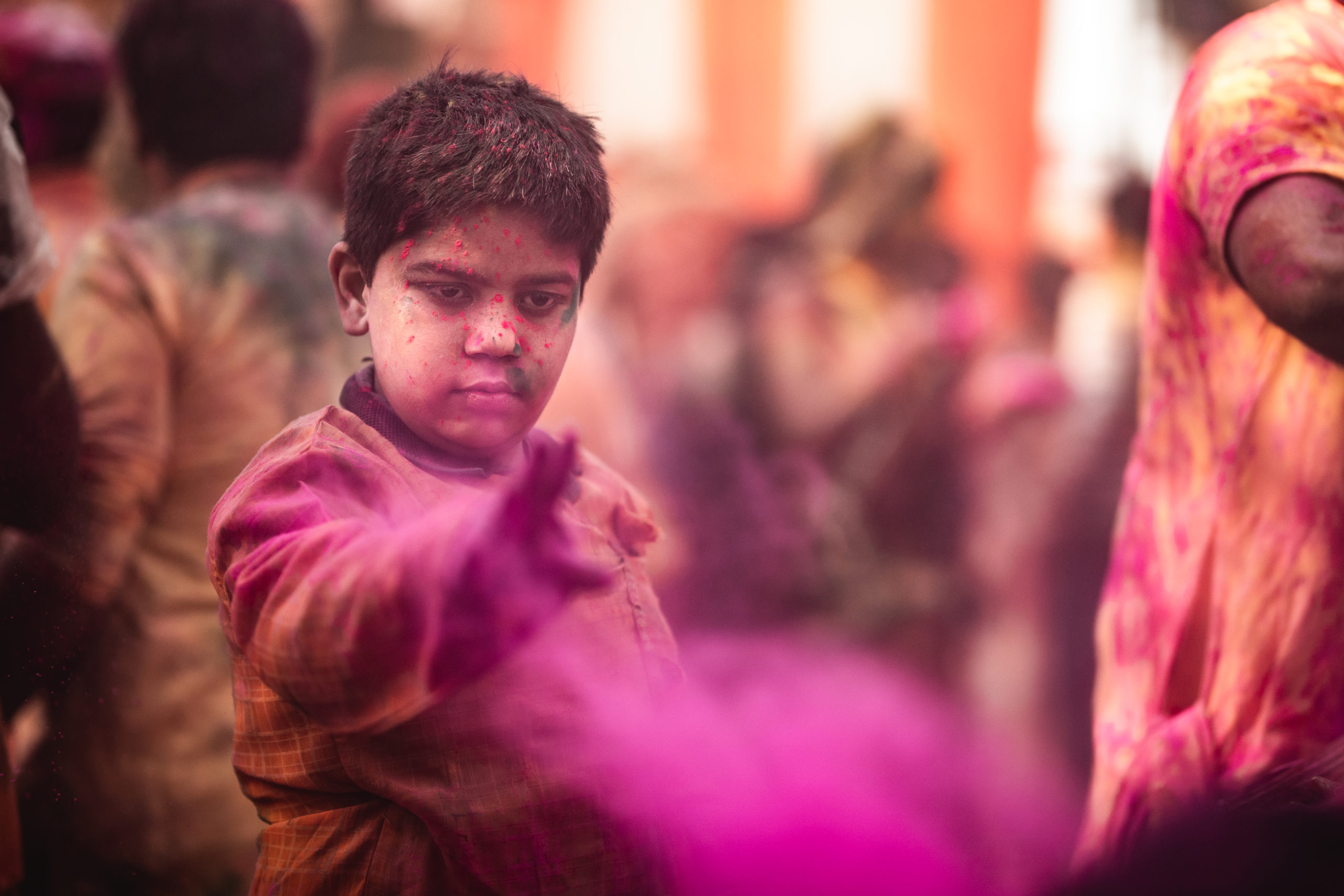 Street photography of a boy celebrating the Holi Festival in a temple in Vrindivan, India