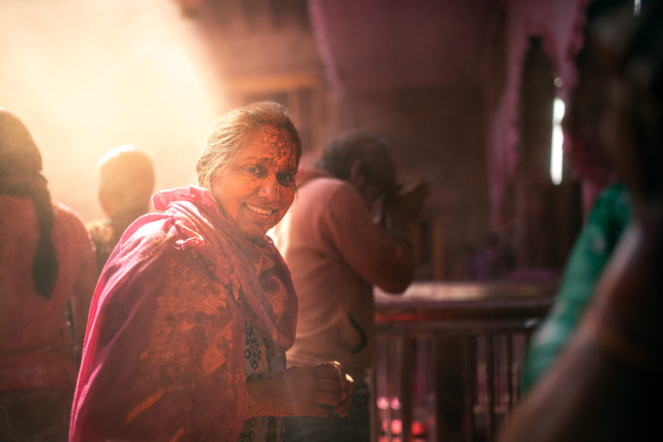 Street photography of a woman celebrating the Holi Festival in a temple in Vrindivan, India