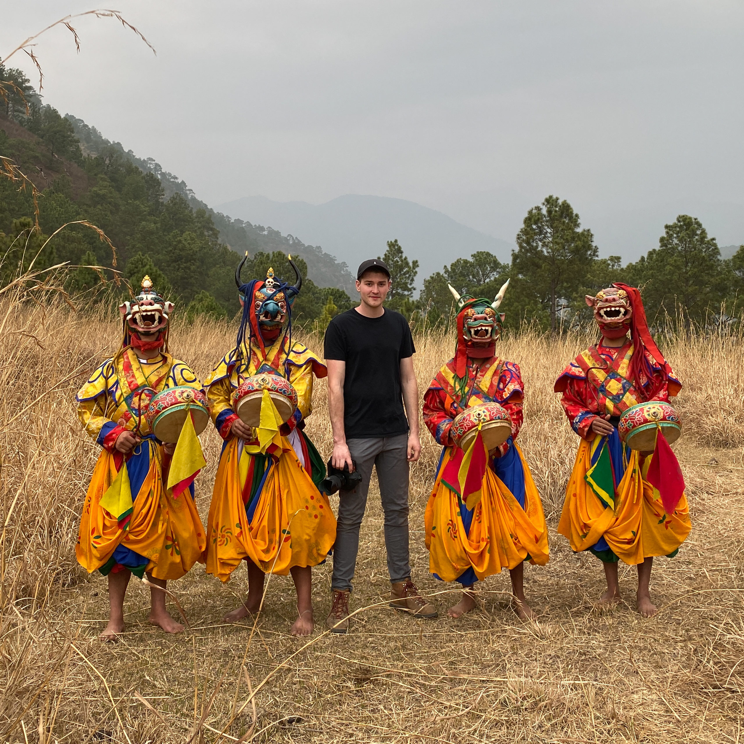 Photographer Andrew Studer stands with Traditional Bhutanese Dancers