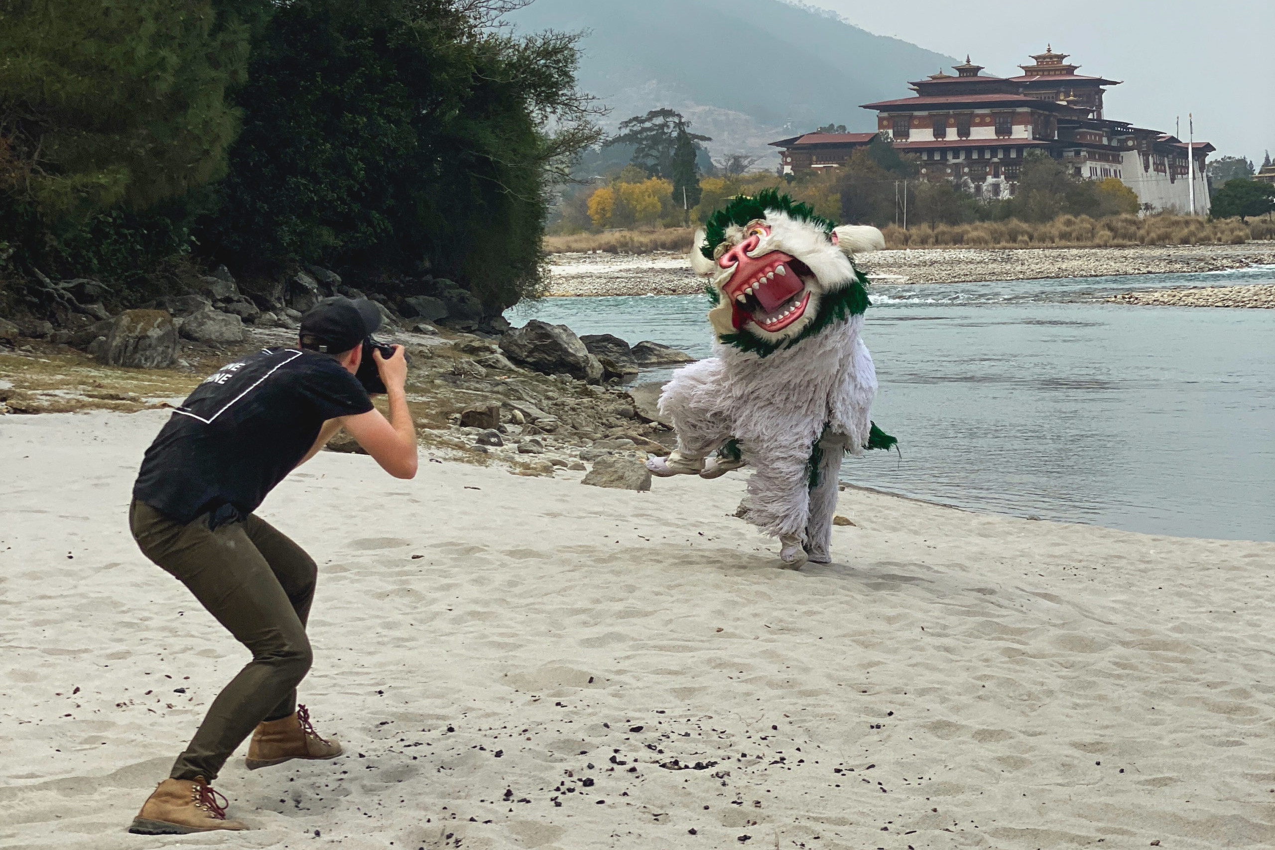 Andrew Studer photographs the traditional Bhutanese dancers in front of Punakha Dzong in Bhutan.