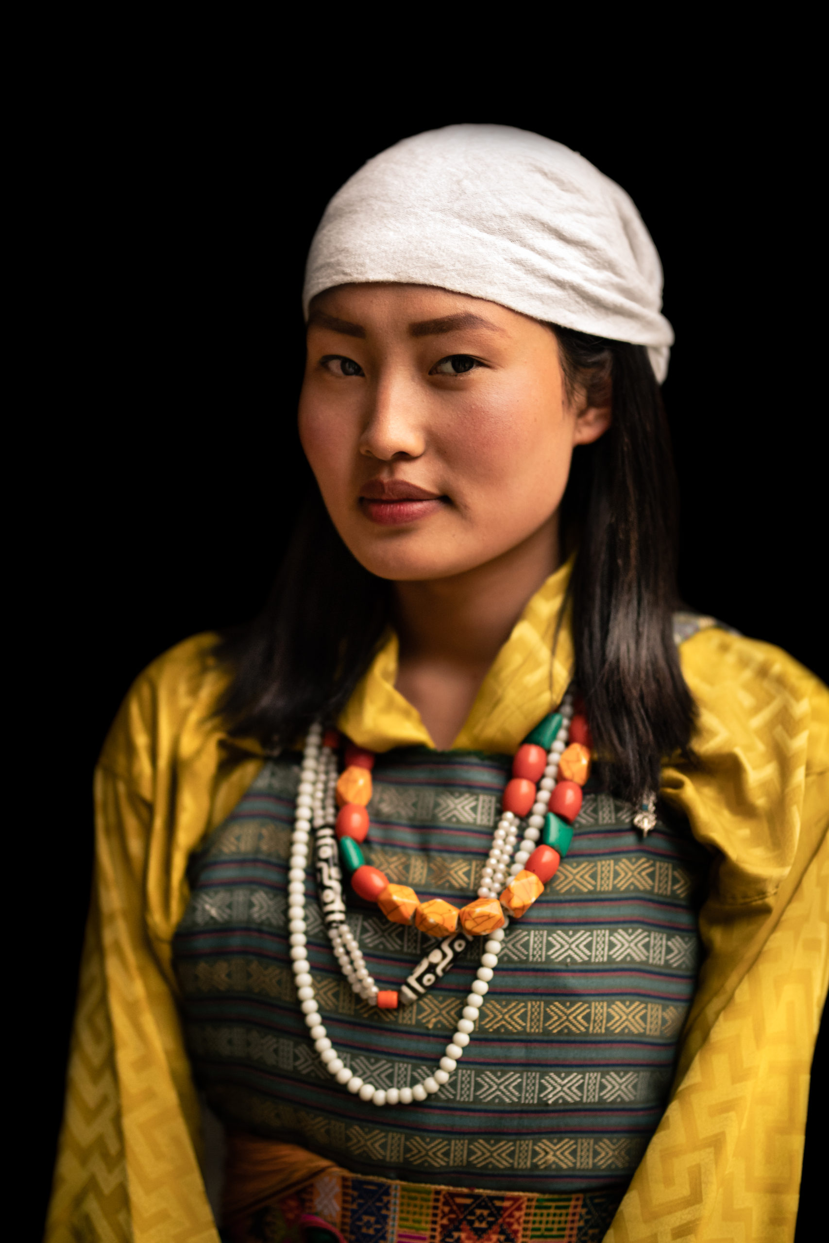 a young Bhutanese girl wears the traditional dance outfit of Bhutan