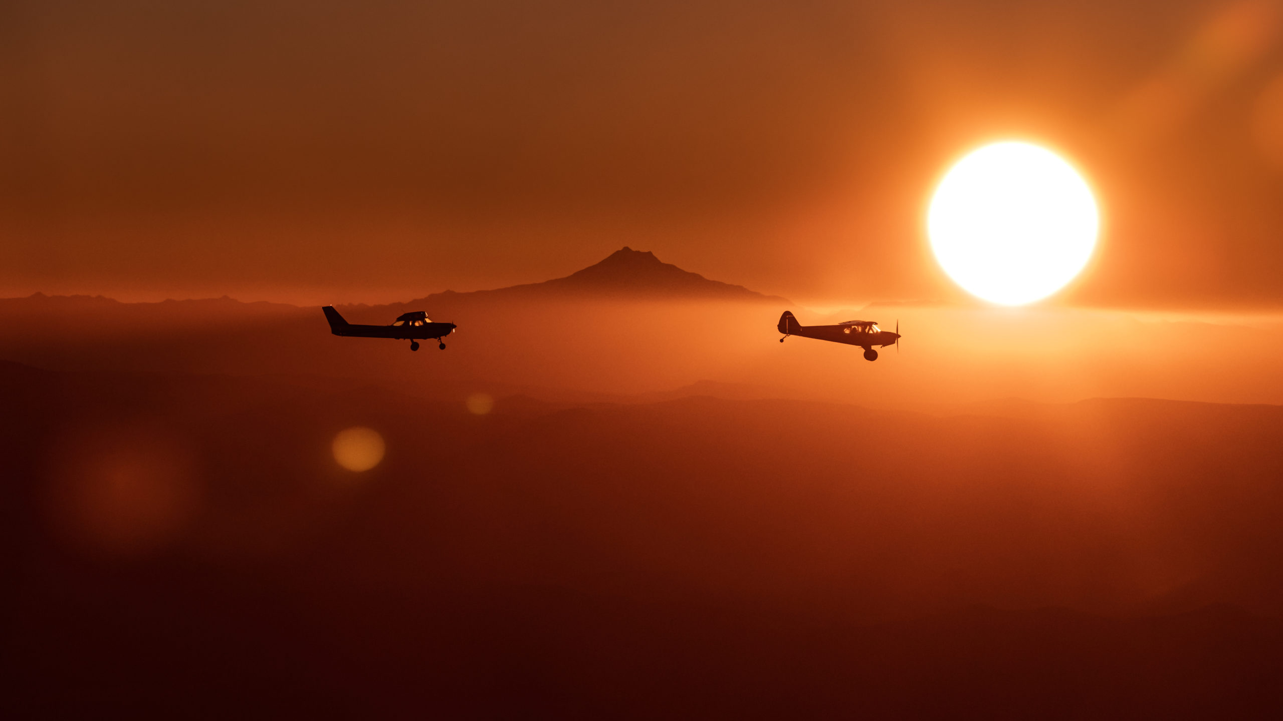 Aviation Photography of two airplanes flying near Mount Jefferson in Oregon during Sunset. Shot using a telephoto lens.