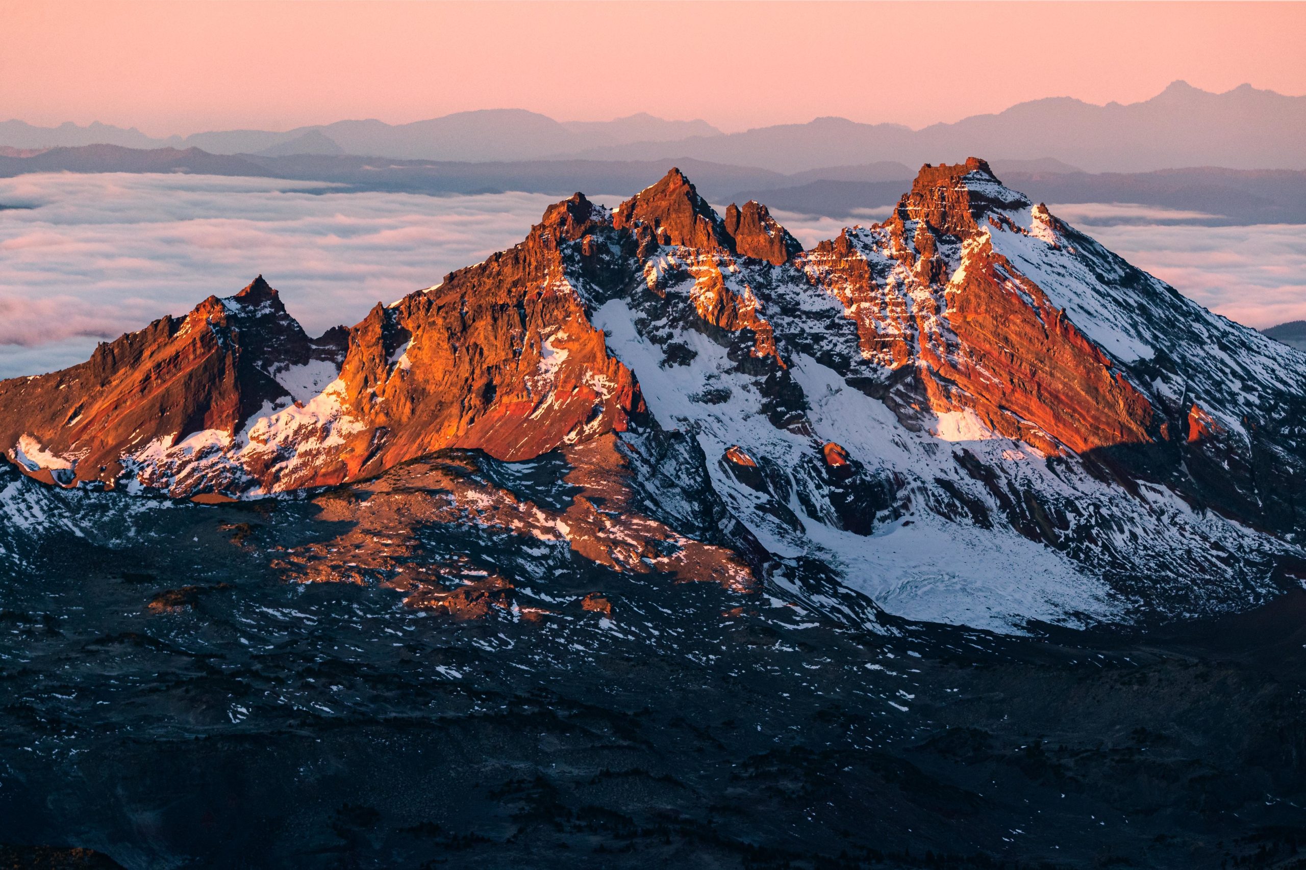 Aerial photography of Broken Top Mountain taking during sunrise in Oregon's Central Cascade Range near Bend.