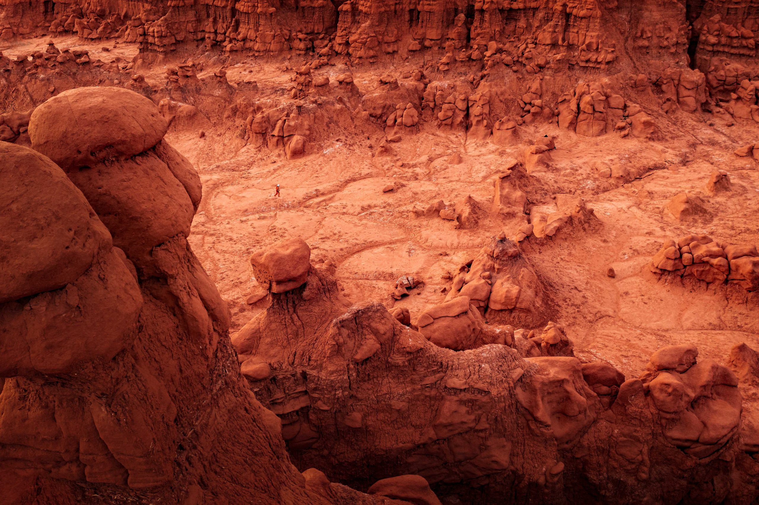 An astronaut explores the Mars-Like landscape of Goblin Valley, Utah
