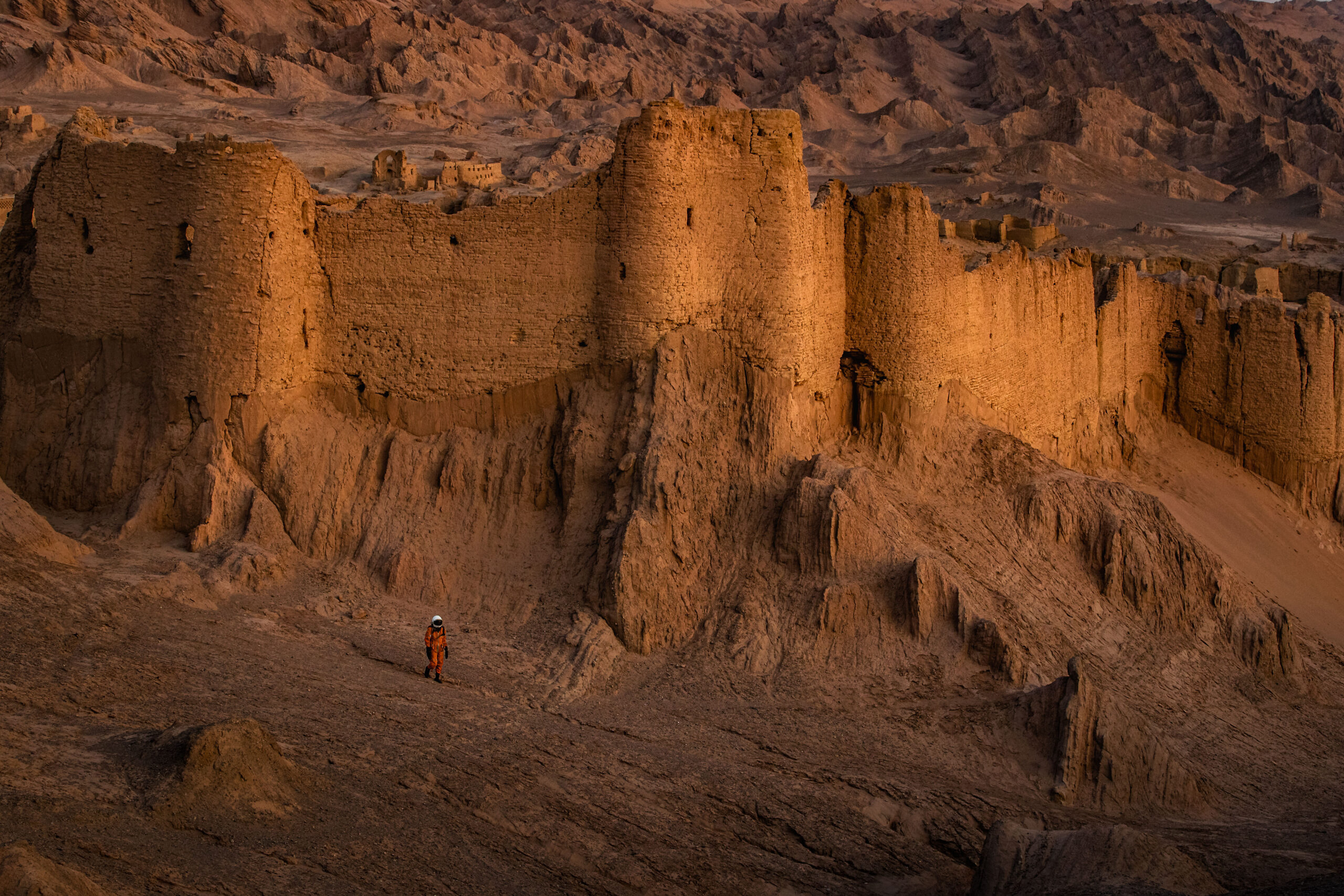 Photography of an astronaut exploring the otherworldly ancient ruins of a castle in Iran