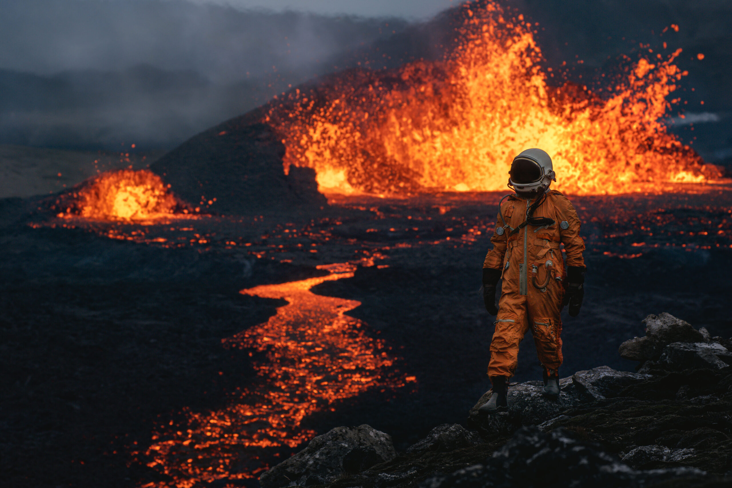 An astronaut stands next to the Fagradalsfjall eruption in Iceland.