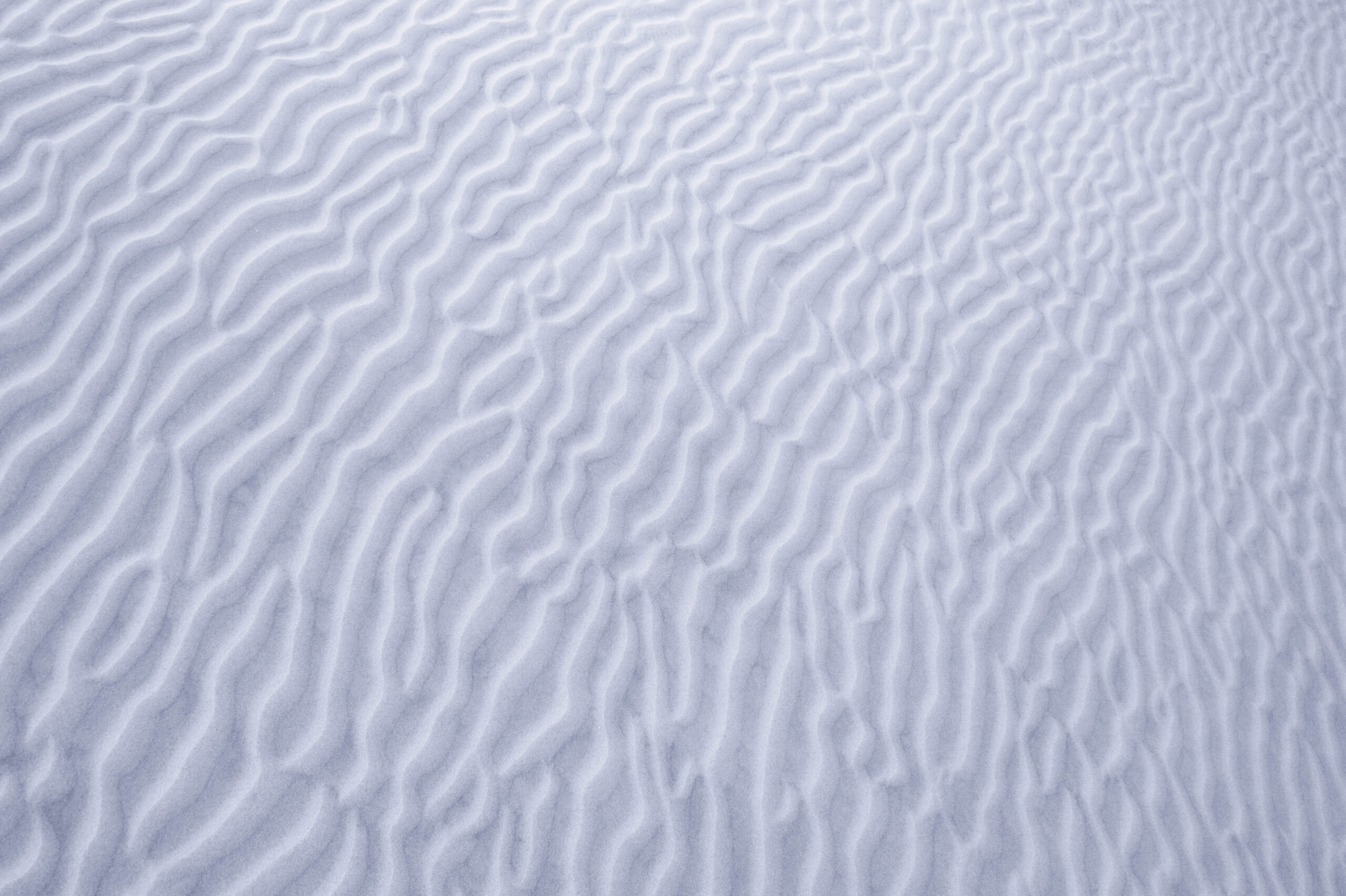 Abstract landscape photography of windblown patterns in a sand dune.