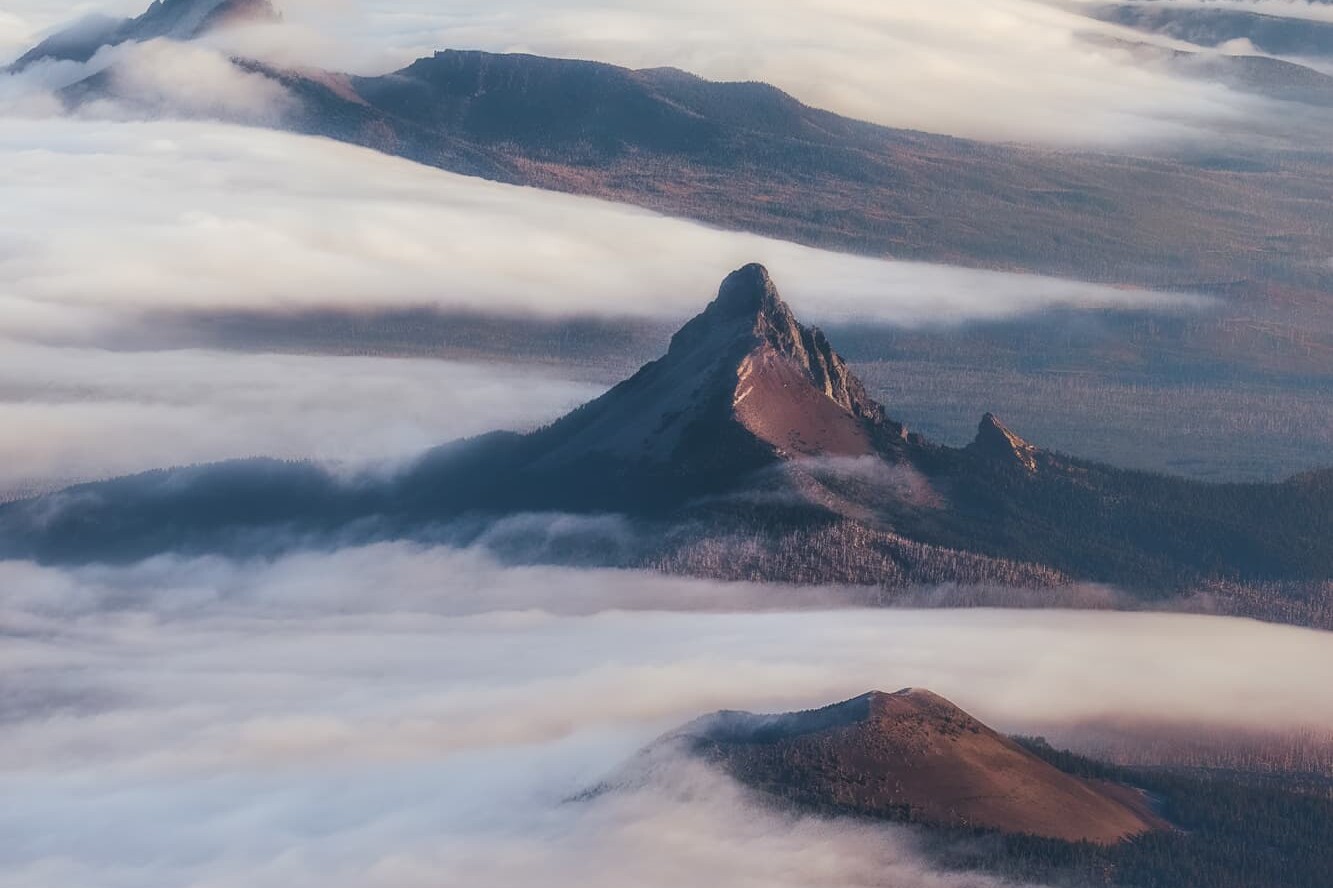 Aerial landscape photography over Oregon's Central Cascade Mountain Range with low fog