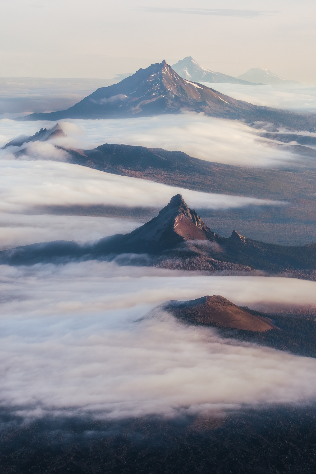 Aerial landscape photography over Oregon's Central Cascade Mountain Range with low fog